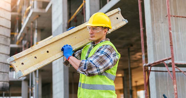 Construction Worker Carrying Wood 