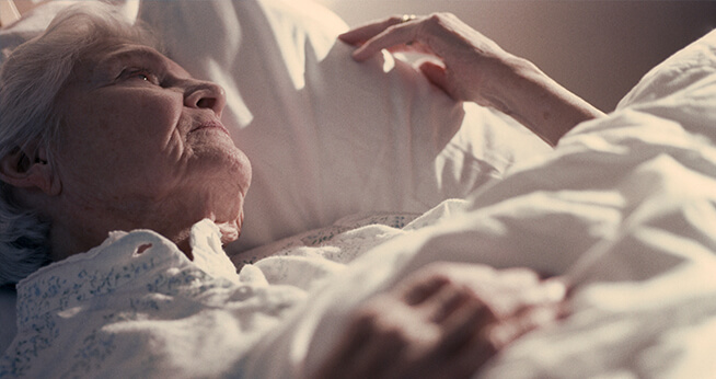 Elderly Woman laying in bed